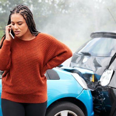 Female Motorist Involved In Car Accident Calling Insurance Company Or Recovery Service